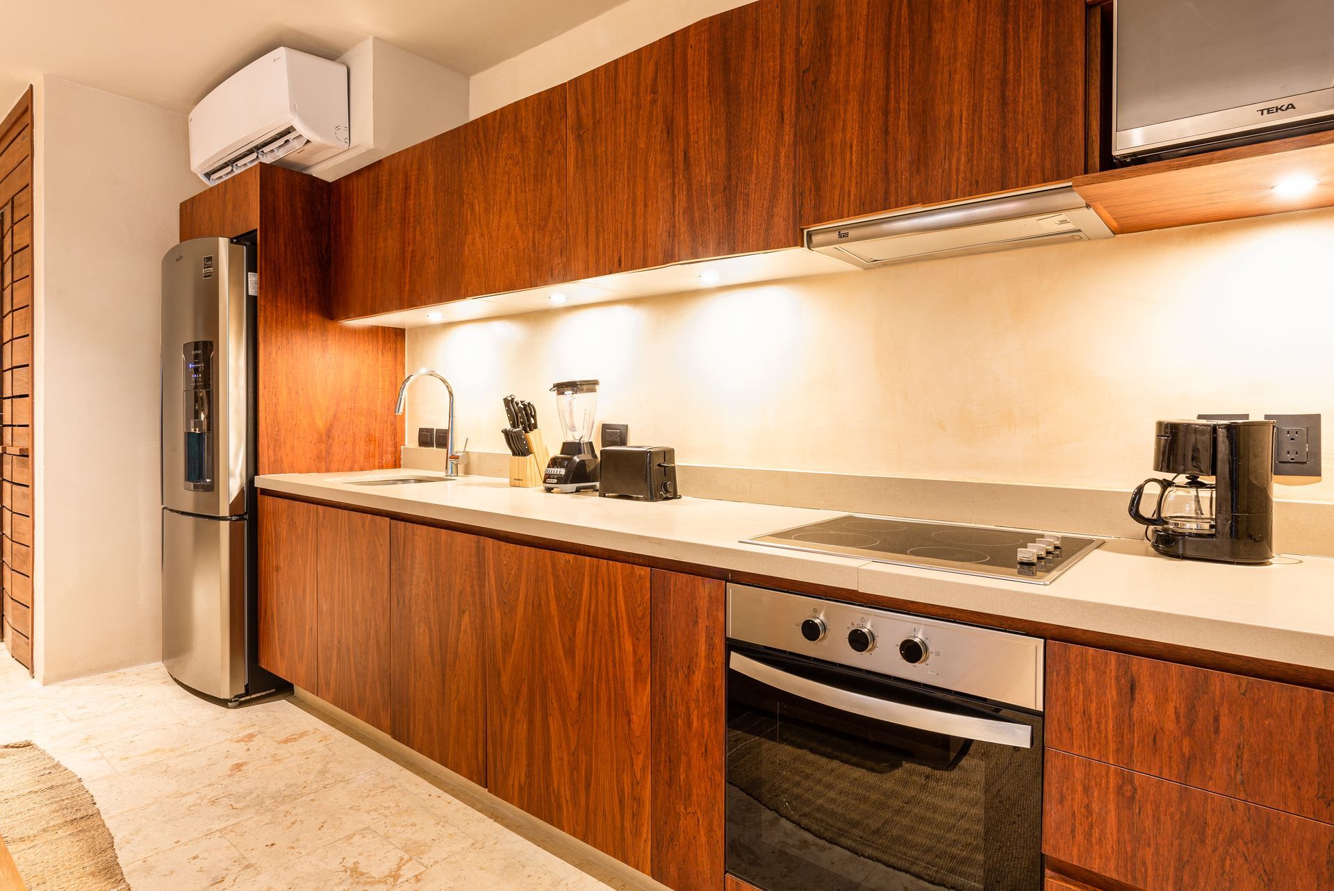 A kitchen with wooden cabinets and stainless steel appliances.