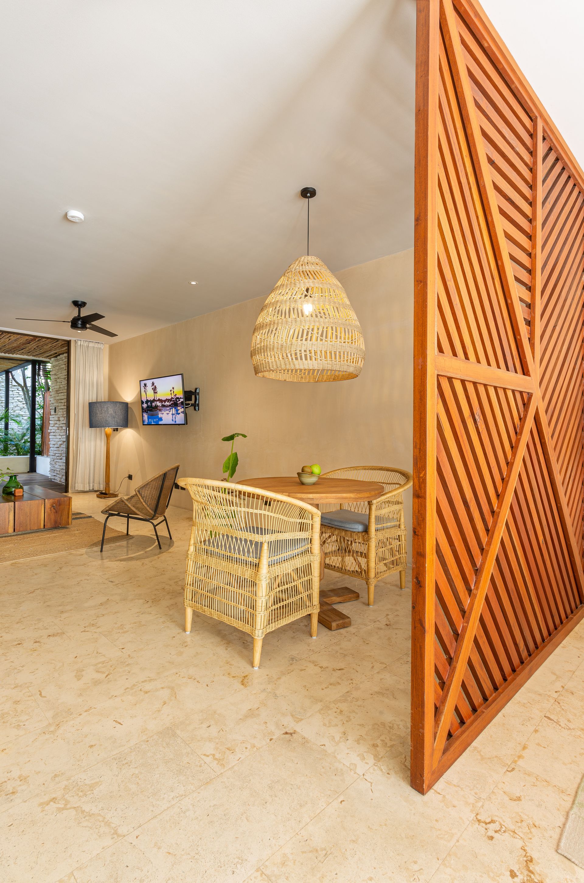 A living room with a wooden divider between the dining room and the living room.