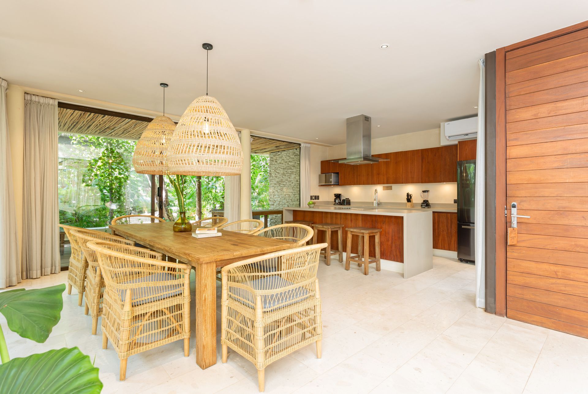 There is a dining table and chairs in the middle of the room.