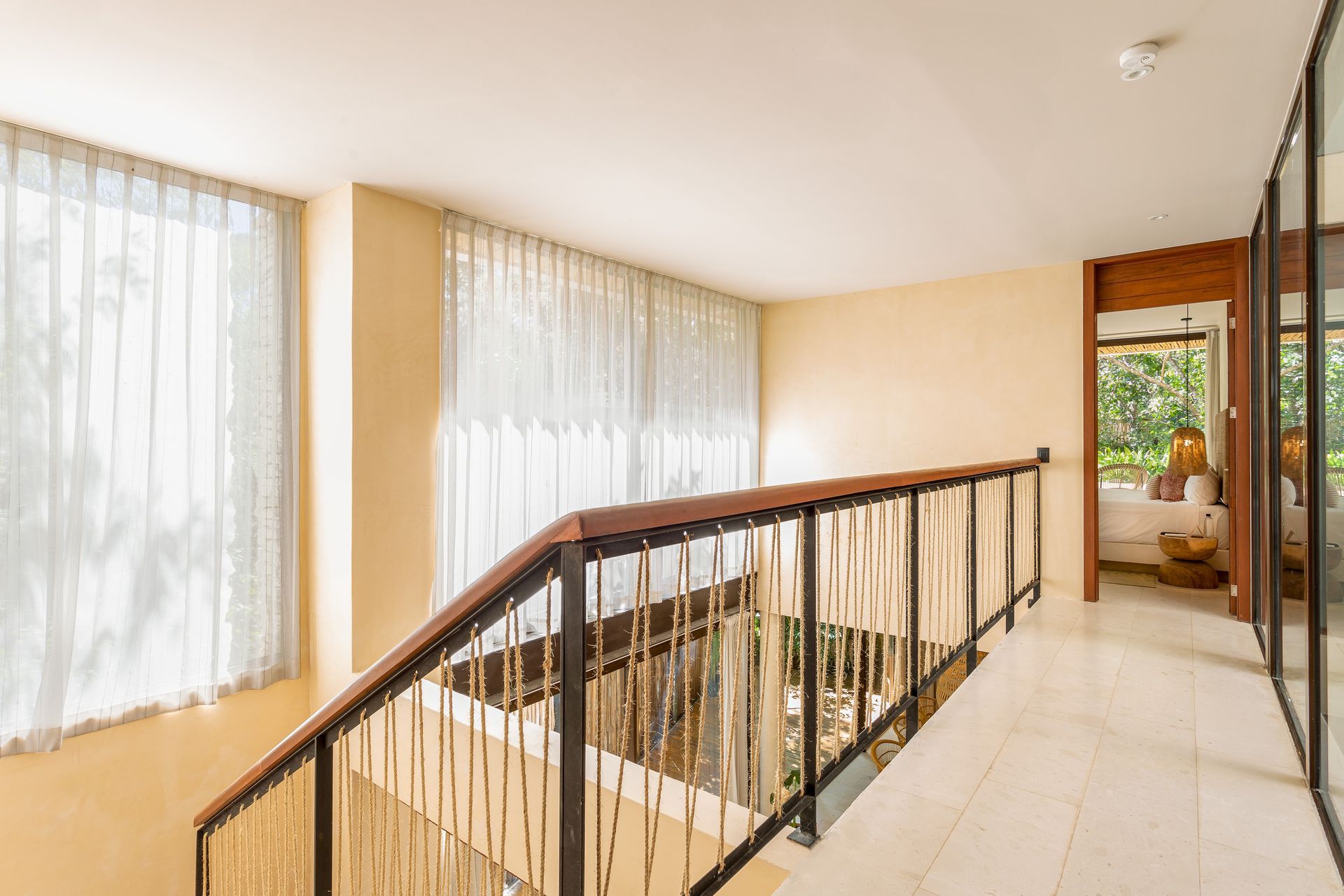 There is a staircase in the middle of the room with a railing.