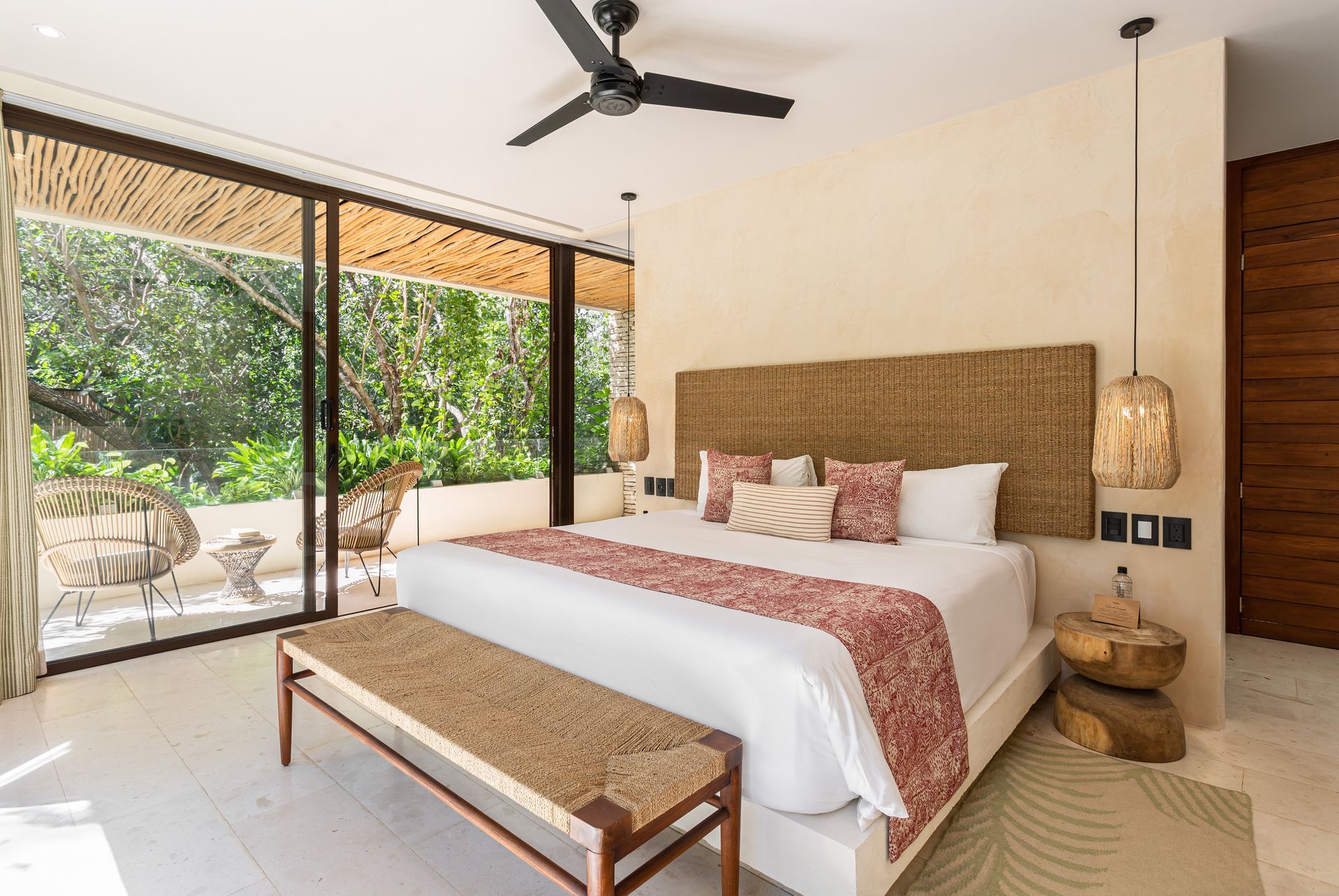 A bedroom with a king size bed and a ceiling fan.