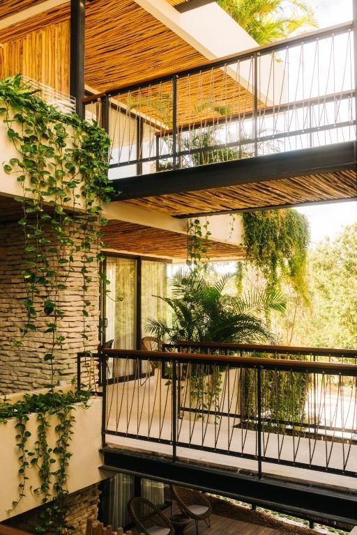 A building with a lot of windows and plants growing on the walls.
