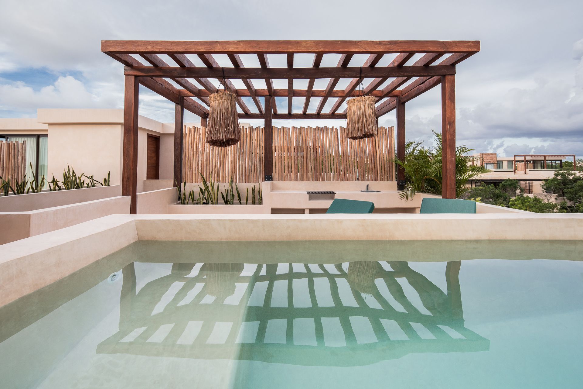A swimming pool with a pergola on top of it