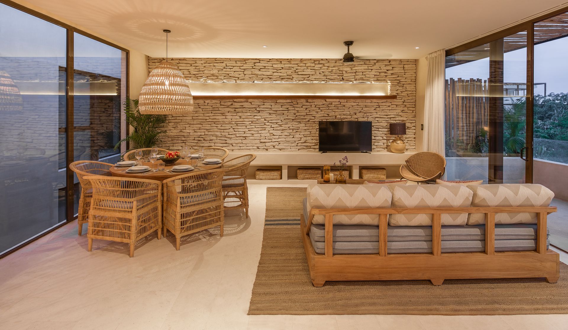 A living room with a couch , chairs , a table and a television.
