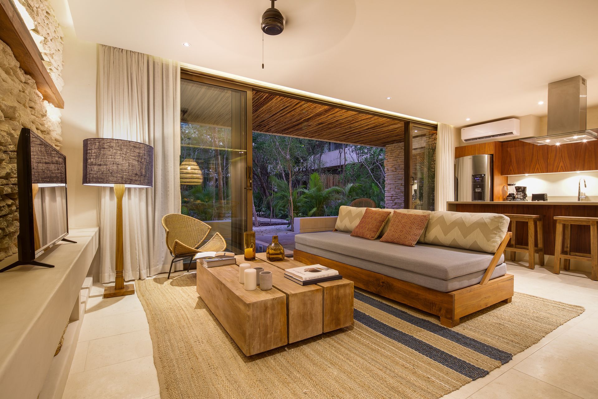 A living room with a couch , coffee table , and television.