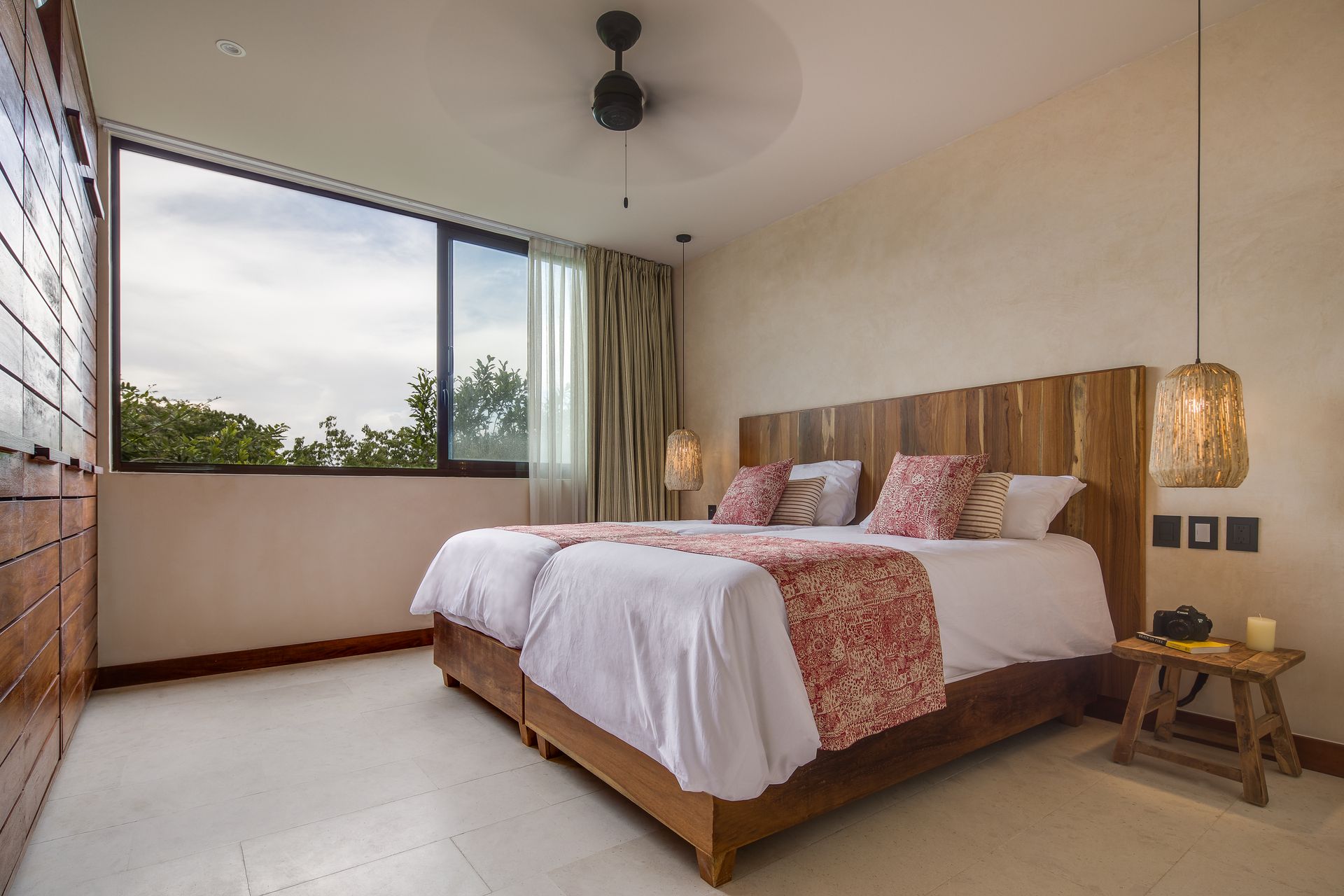 A hotel room with two beds and a ceiling fan.