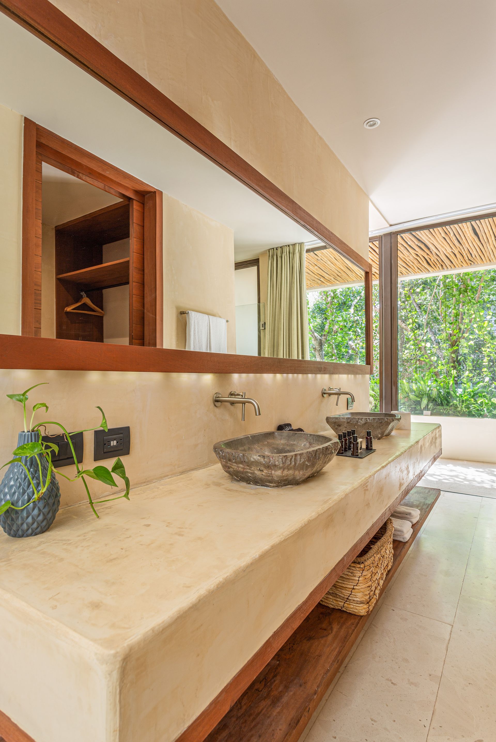 A bathroom with two sinks and a large mirror.