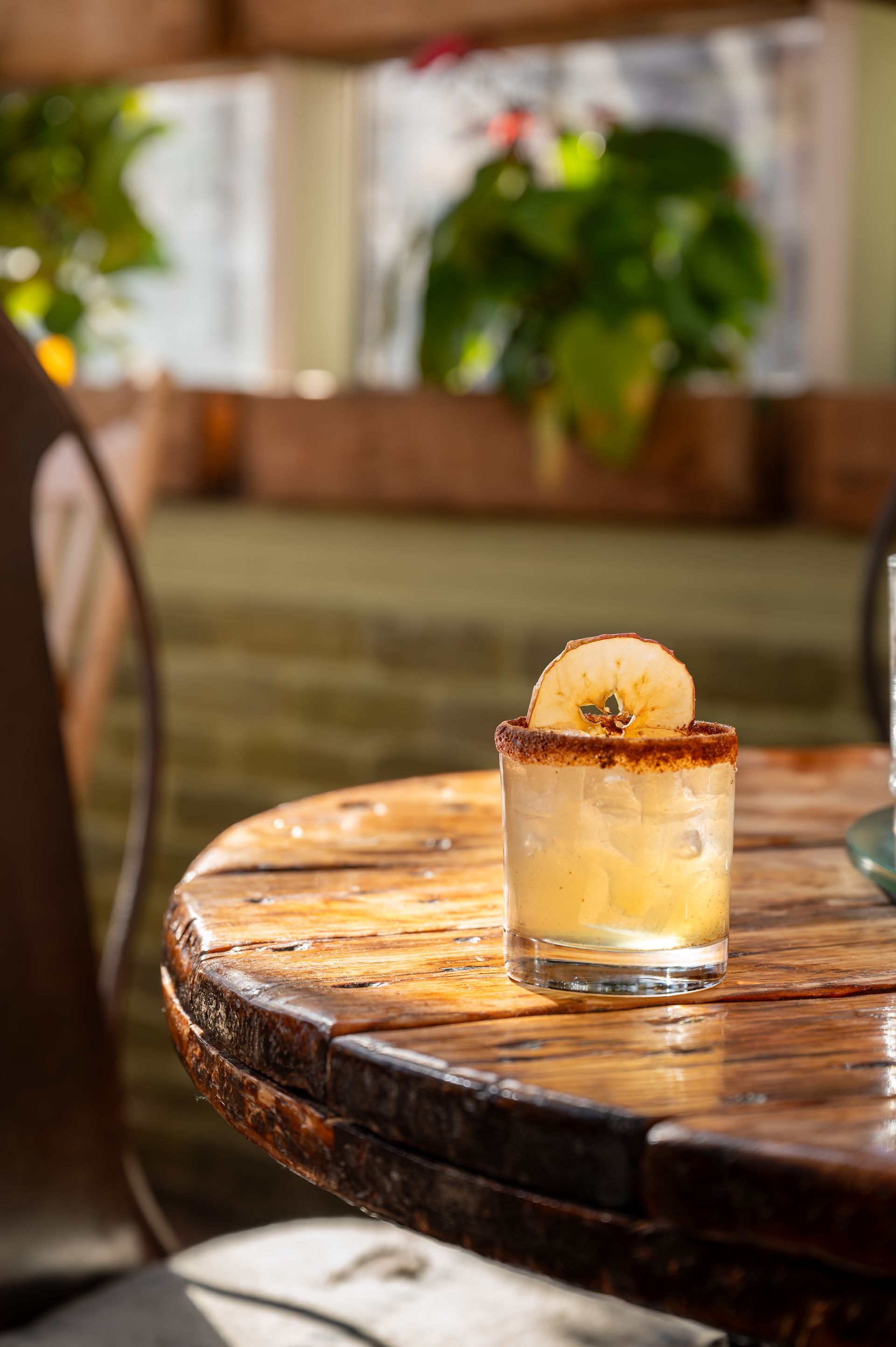 A close up of a drink on a wooden table.