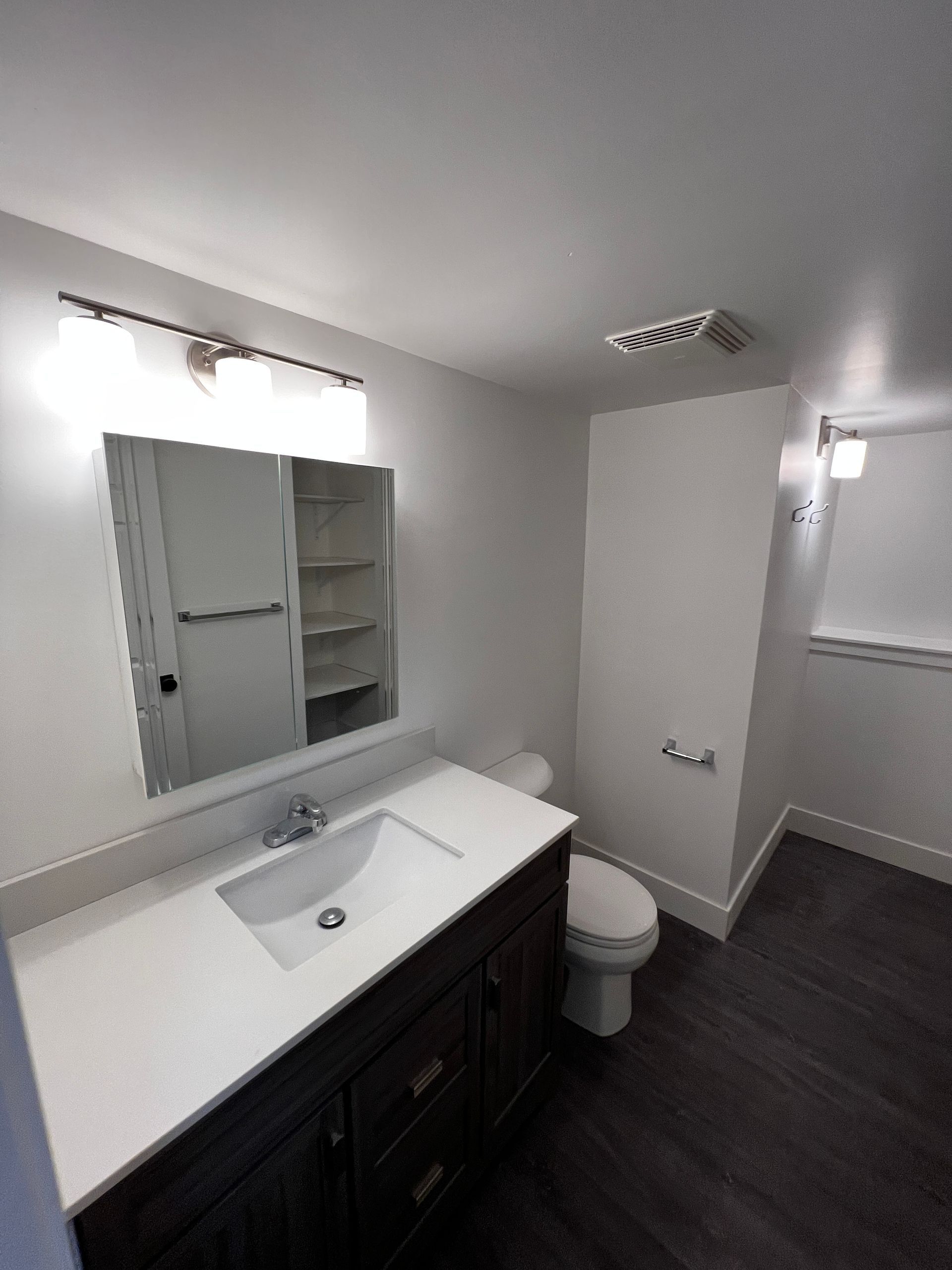 Custom Bathroom Renovations - A bathroom with a sink , toilet and mirror.