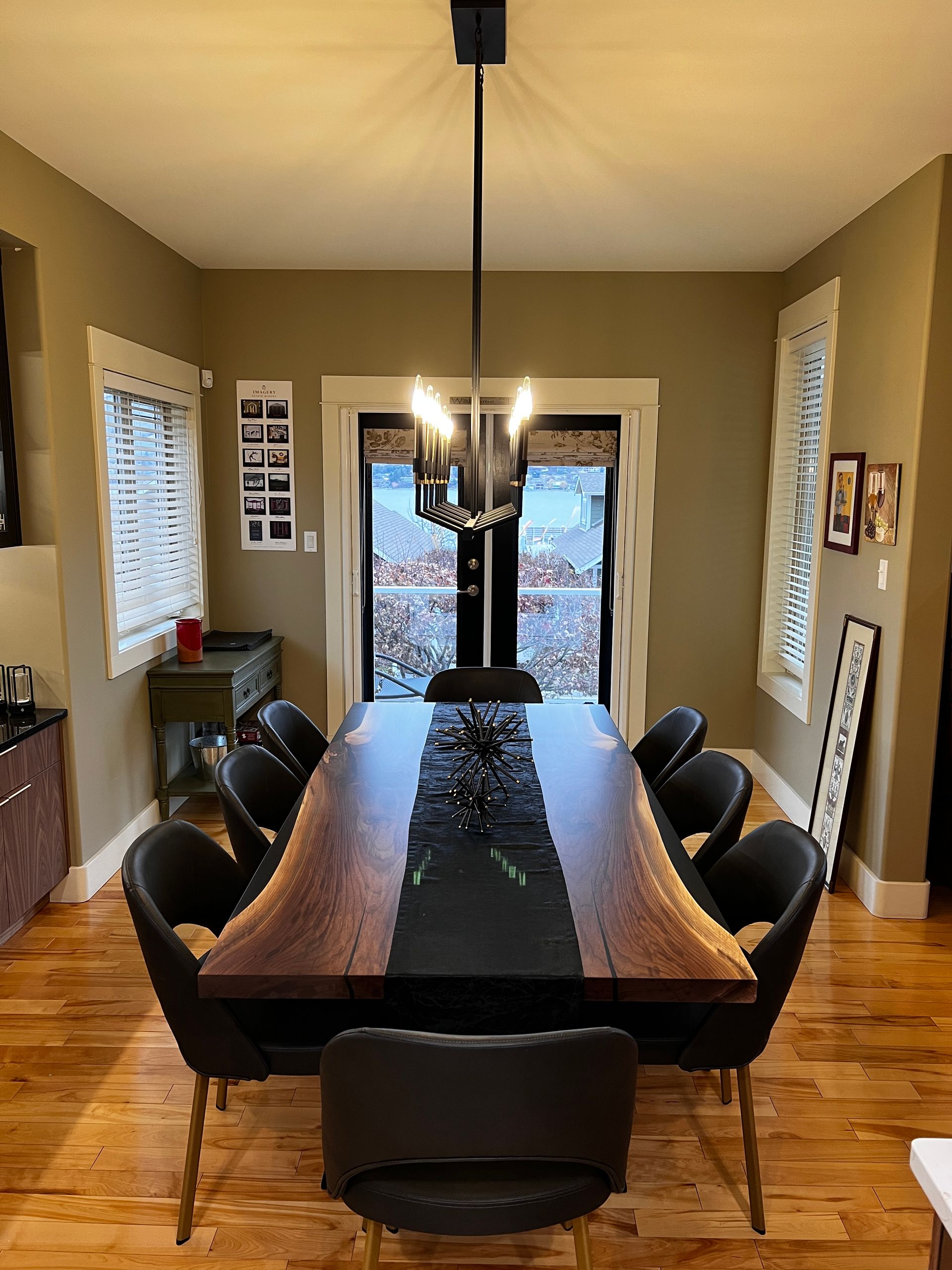Custom Kitchen Renovation - A dining room with a table and chairs and a chandelier