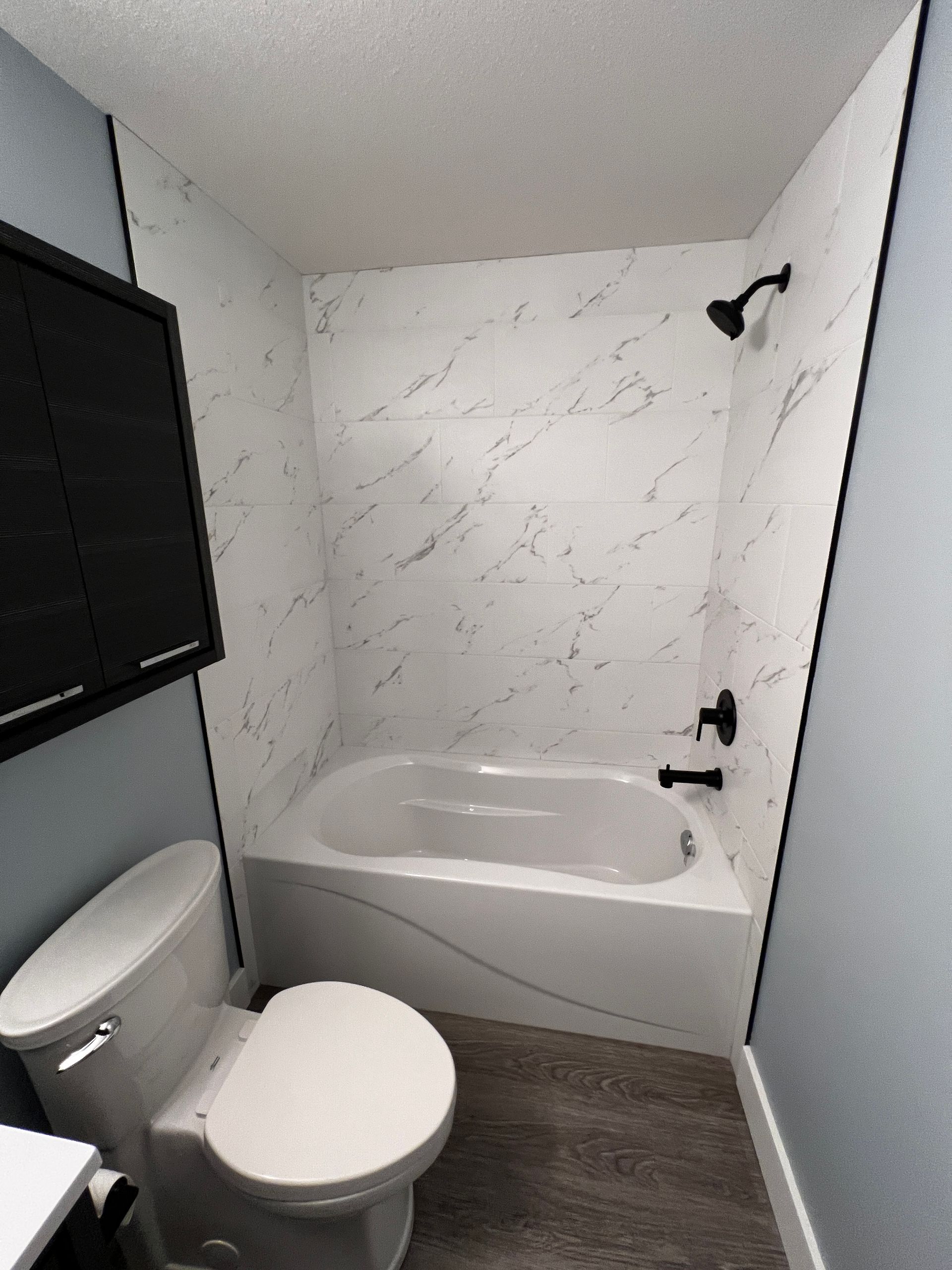 Custom Bathroom Renovations - A bathroom with a toilet , bathtub and shower.
