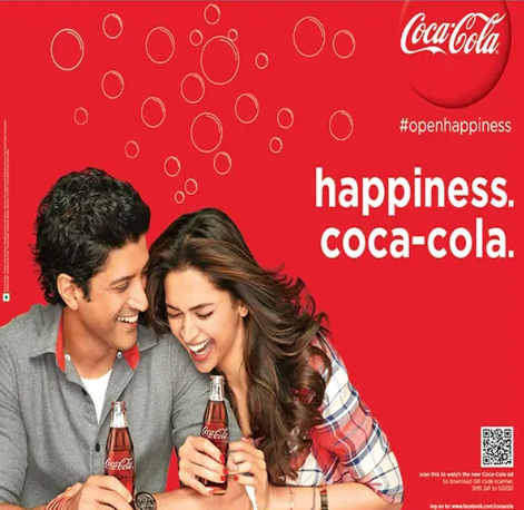 An advertisement for coca-cola shows a man and a woman holding coca-cola An advertisement for coca-cola shows a man and a woman holding coca-cola bottles
