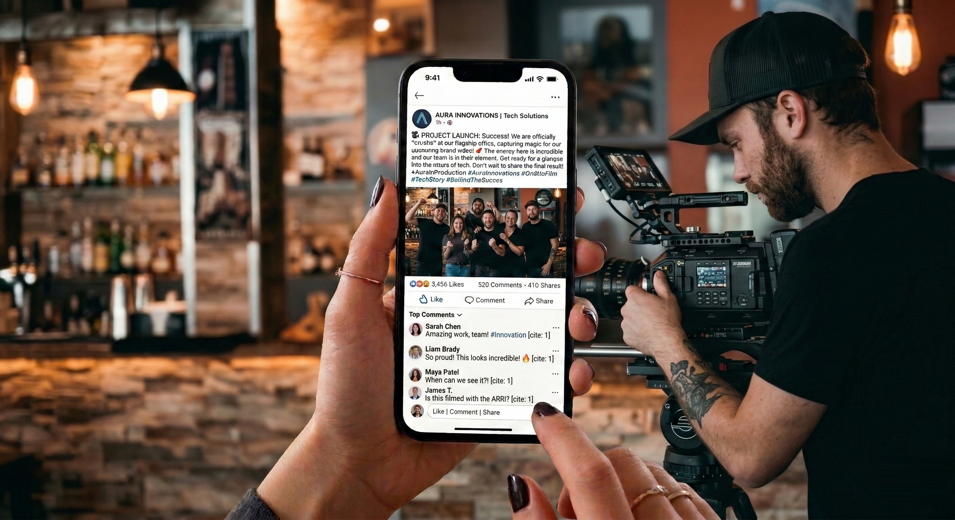 A person holding a phone showing a social media post, with a videographer operating a camera in the background.