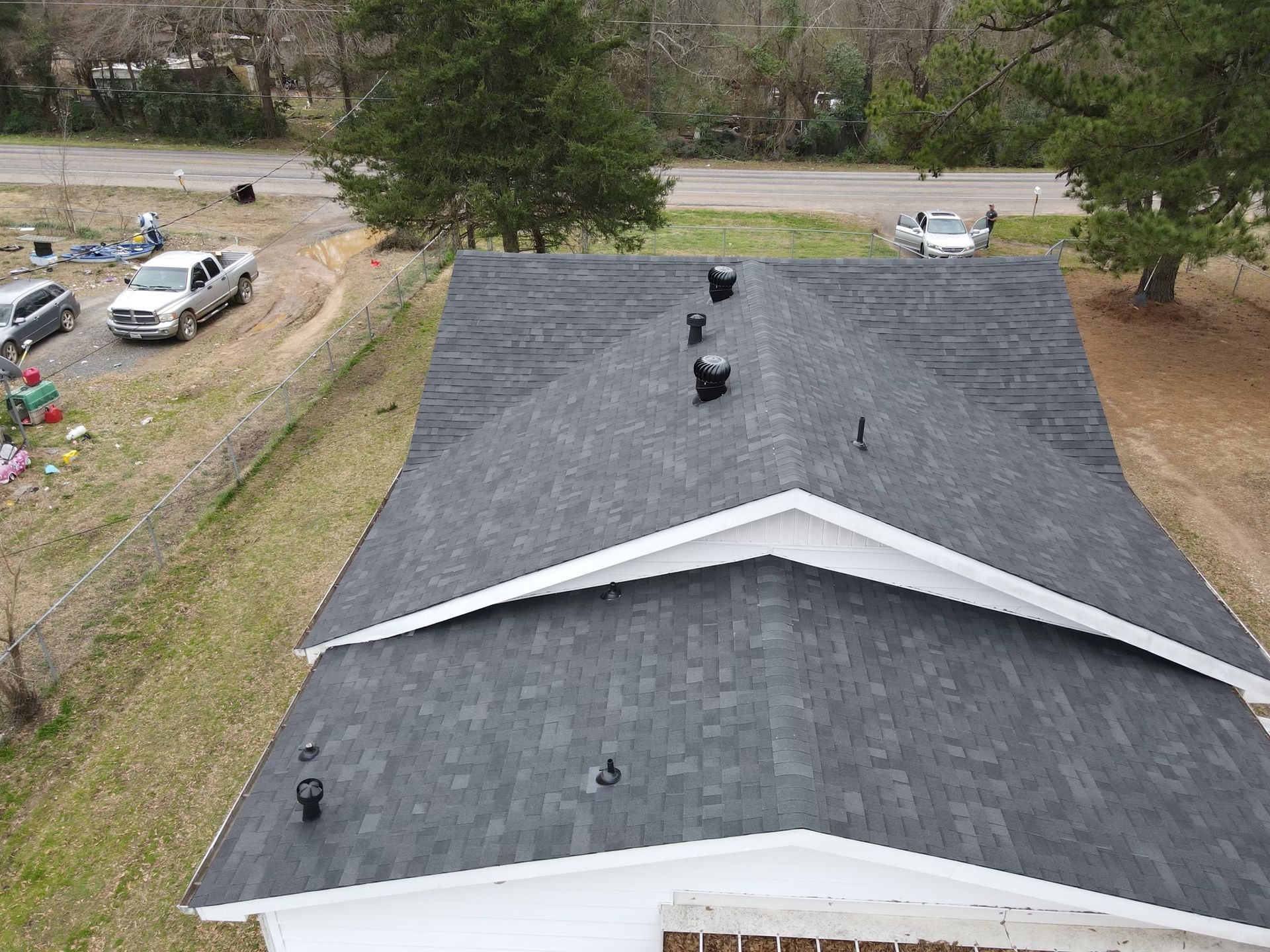 An aerial view of a house with a new roof.