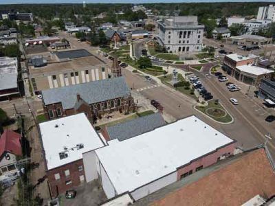 An aerial view of a small town with a white roof.