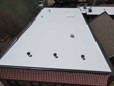 An aerial view of a white roof on a building.