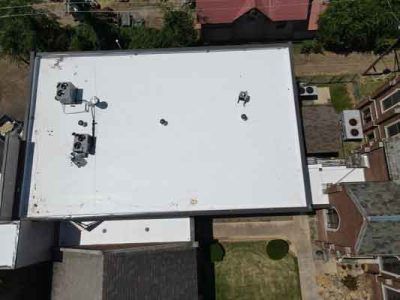 An aerial view of a building with a white roof.