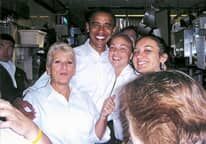 A group of people are posing for a picture with barack obama.