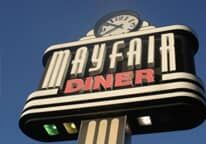 A mayfair diner sign with a clock on top of it.