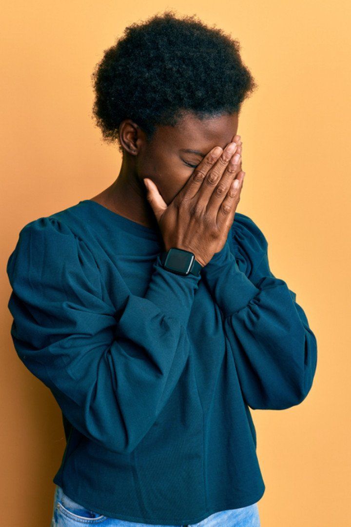 Young african american girl wearing casual clothes with sad expression covering face with hands while crying