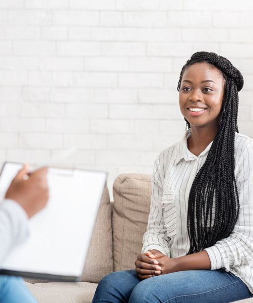 Happy african american woman sitting at psychologist office after successful session