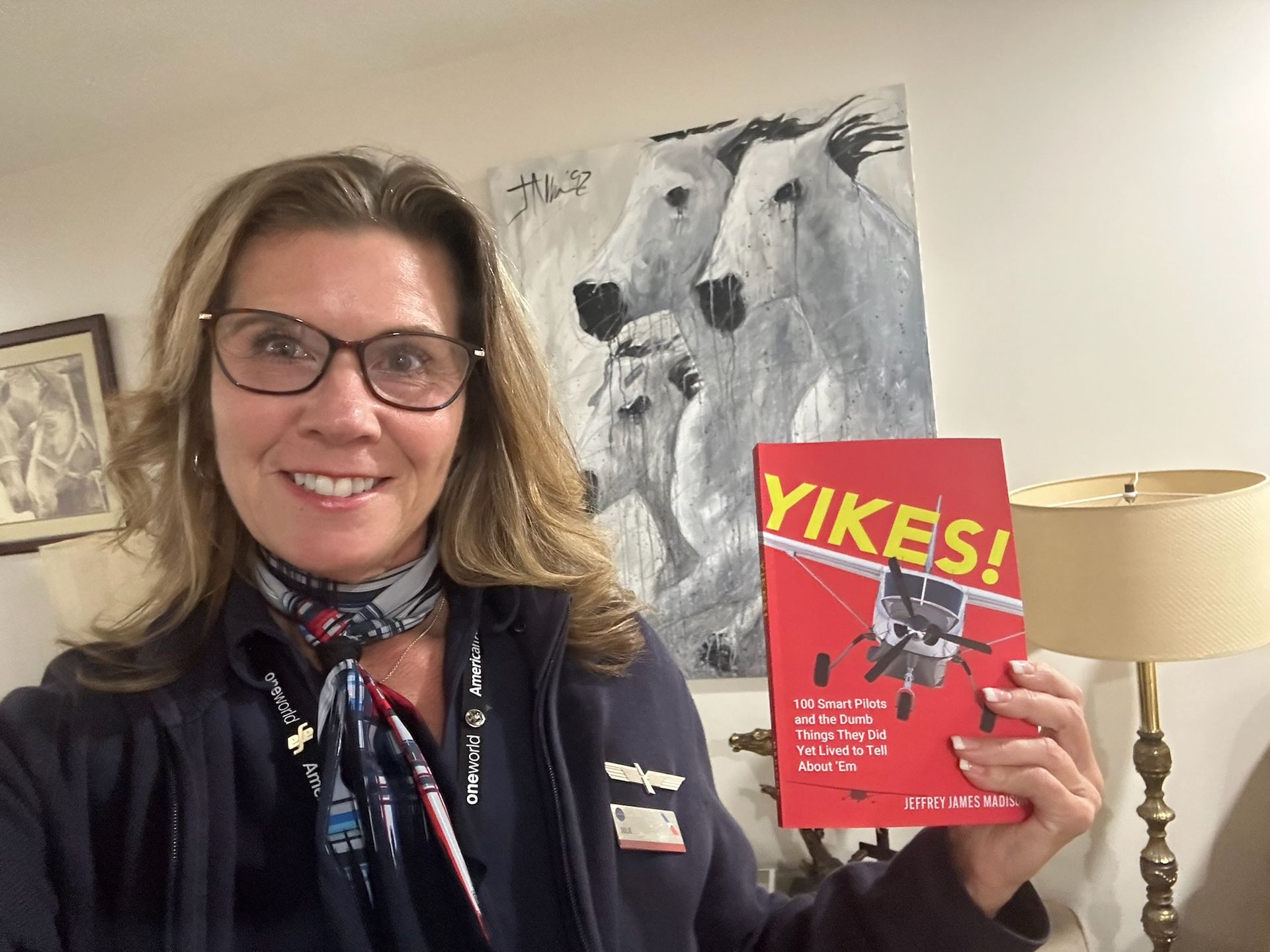 A woman is holding a book titled yikes