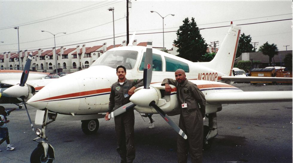 Three men are standing in front of a small plane with the numbers u3802 on the tail