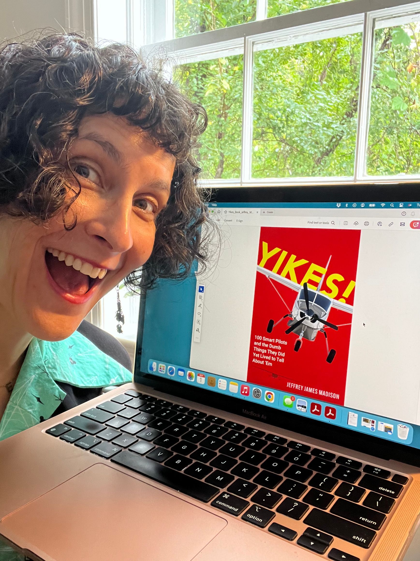 A woman is sitting in front of a laptop computer.