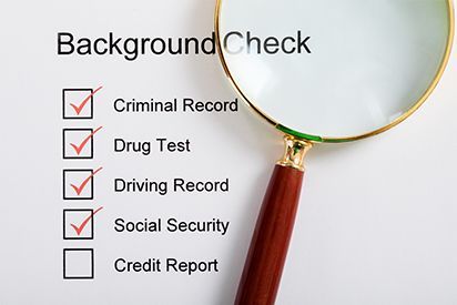 Magnifying glass over a background check checklist