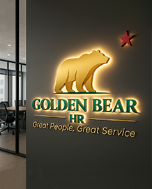 Gold illuminated Golden Bear HR logo with a red star on a gray office wall.