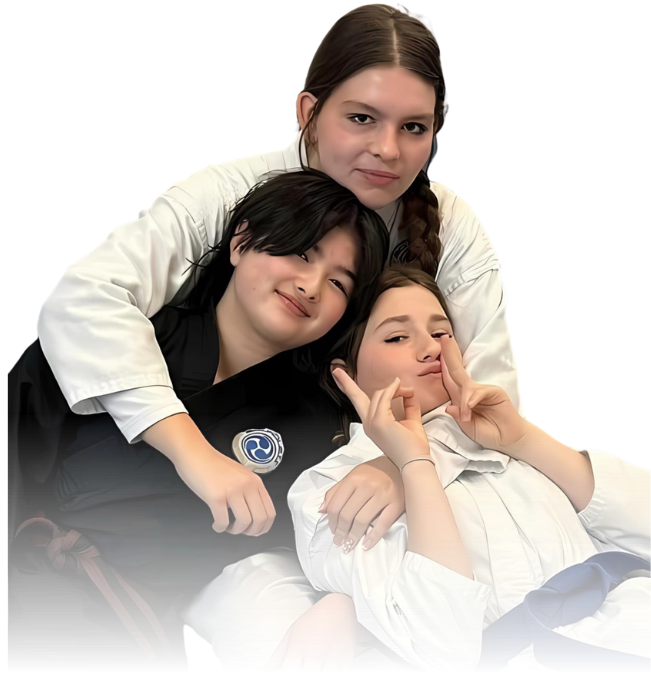 Man pointing, smiling, wearing black hoodie; arm tattoo visible.