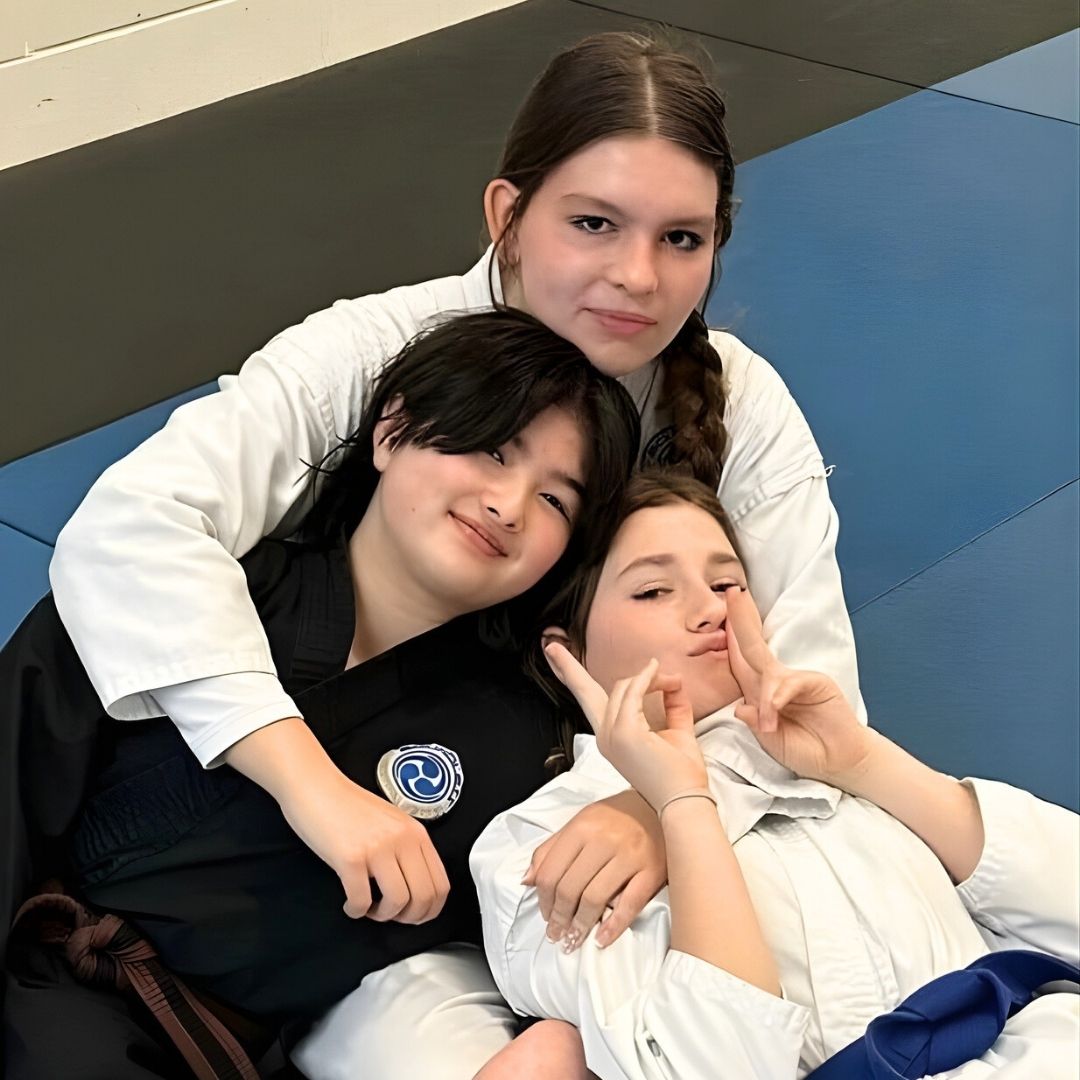 Four men in athletic gear, posing for a photo in a gym.