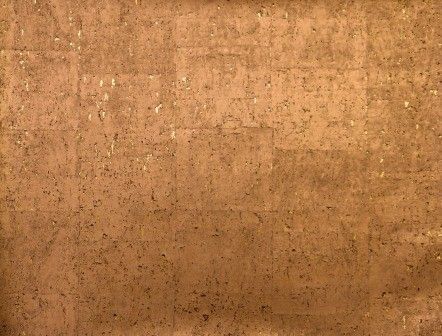 A textured, medium-brown surface resembling natural cork with small dark specks and a subtle, square-tiled pattern.