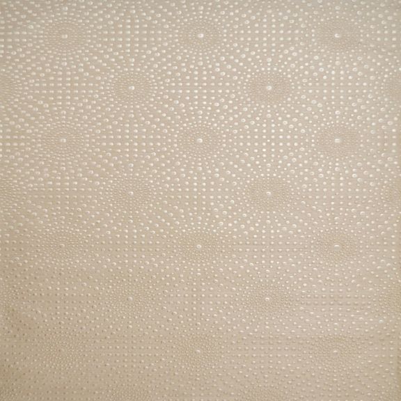 Cream-colored wallpaper with repeating circular patterns made of small dots.
