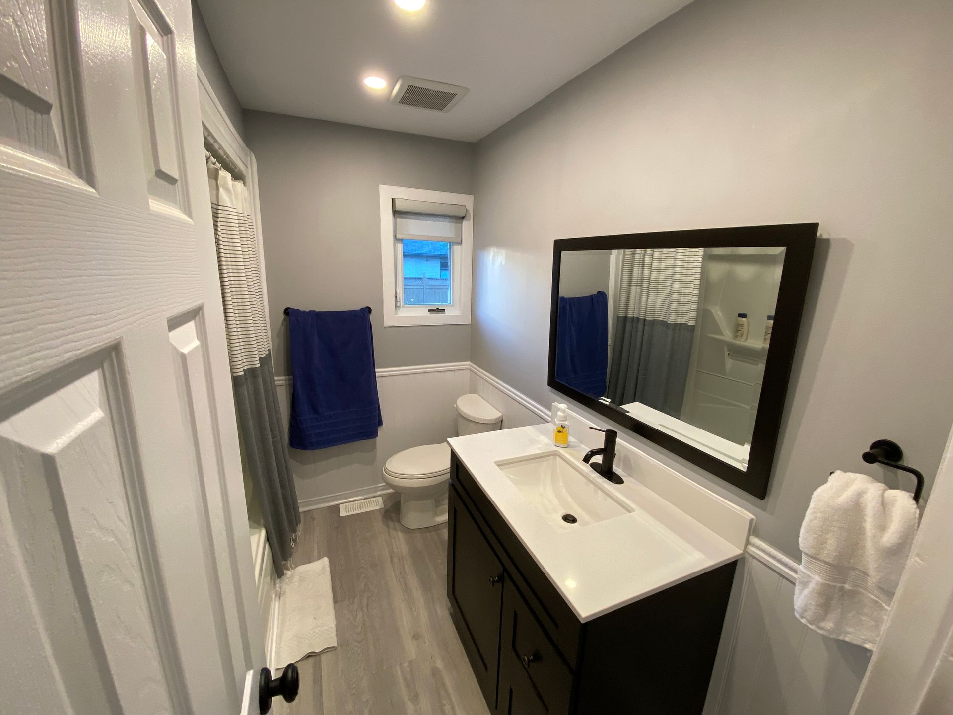 A bathroom with a sink , toilet , and mirror.