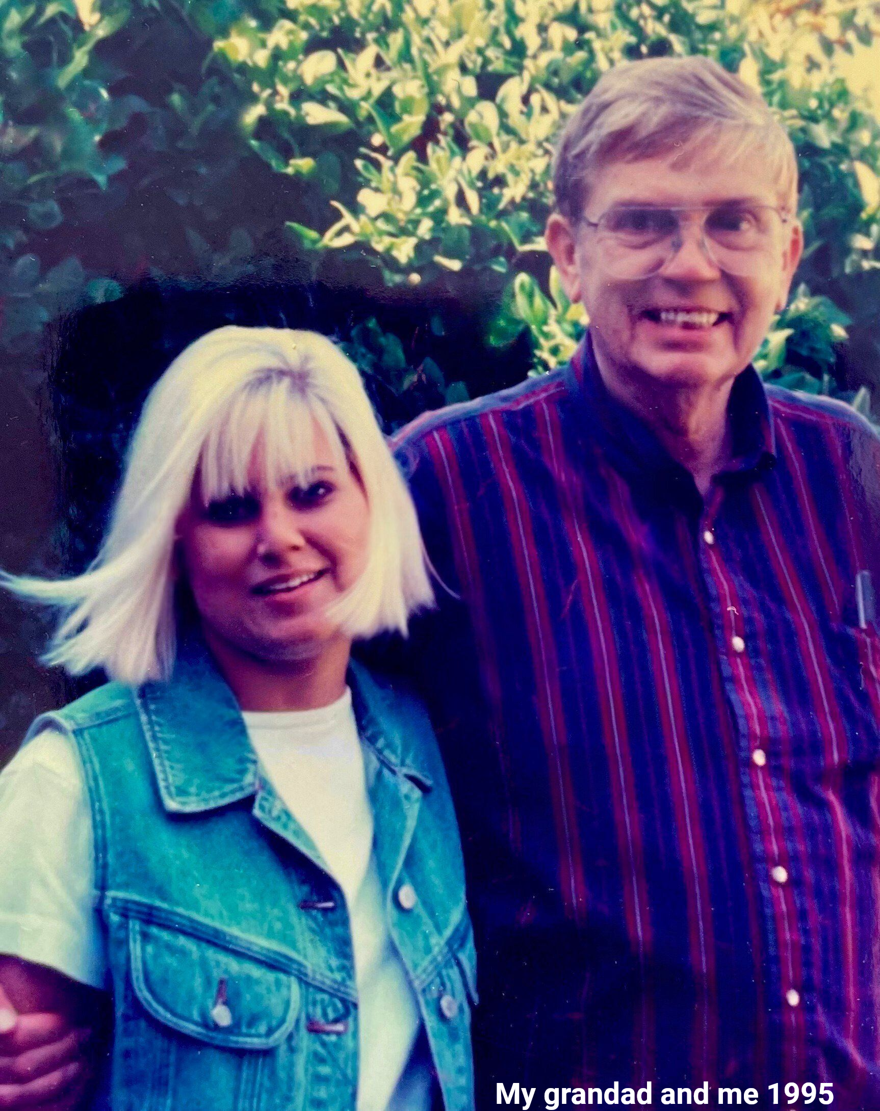A man and a woman are posing for a picture in a black and white photo.
