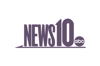 A purple logo for news 10 abc on a white background.