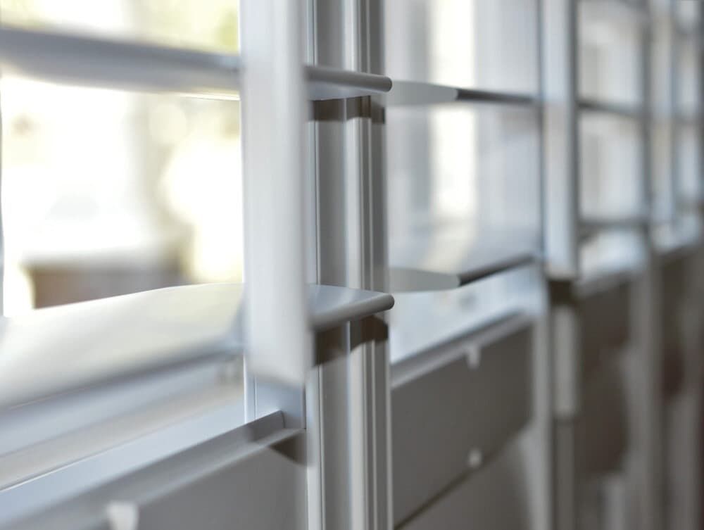 A Close Up Of A Metal Railing With A Window In The Background — Summerland Screens & Awnings In Ballina, NSW