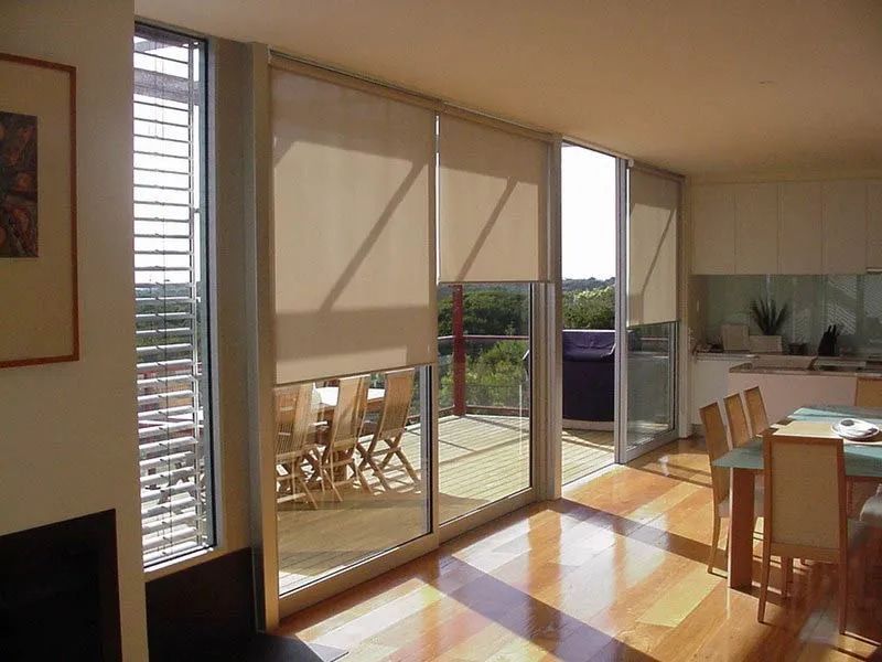 A Dining Room With A Table And Chairs And Sliding Glass Doors — Summerland Screens & Awnings In Ballina, NSW