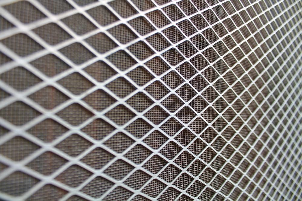 A Close Up Of A Metal Mesh With Holes In It — Summerland Screens & Awnings In Lennox Head, NSW