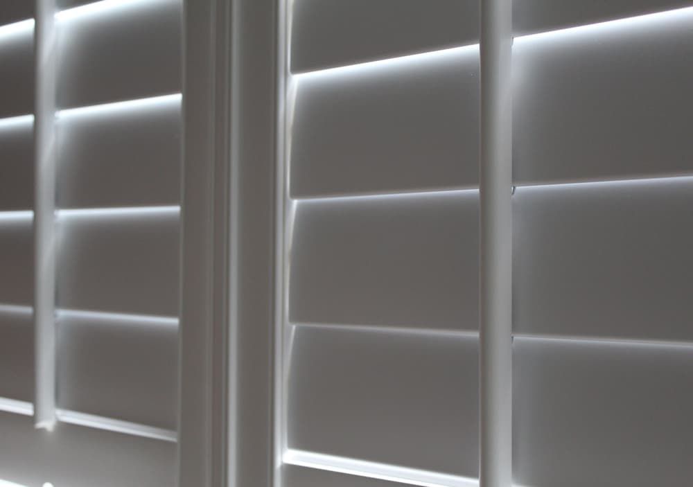 A Close Up Of Three White Shutters On A Window — Summerland Screens & Awnings In Lennox Head, NSW