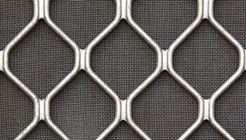 A Close Up Of A Metal Mesh On A Gray Background — Summerland Screens & Awnings In Lennox Head, NSW