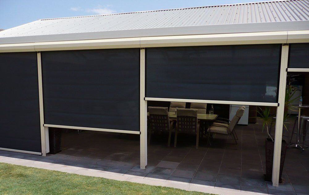 A House With A Patio With A Table And Chairs And Blinds On The Windows — Summerland Screens & Awnings In Ballina, NSW