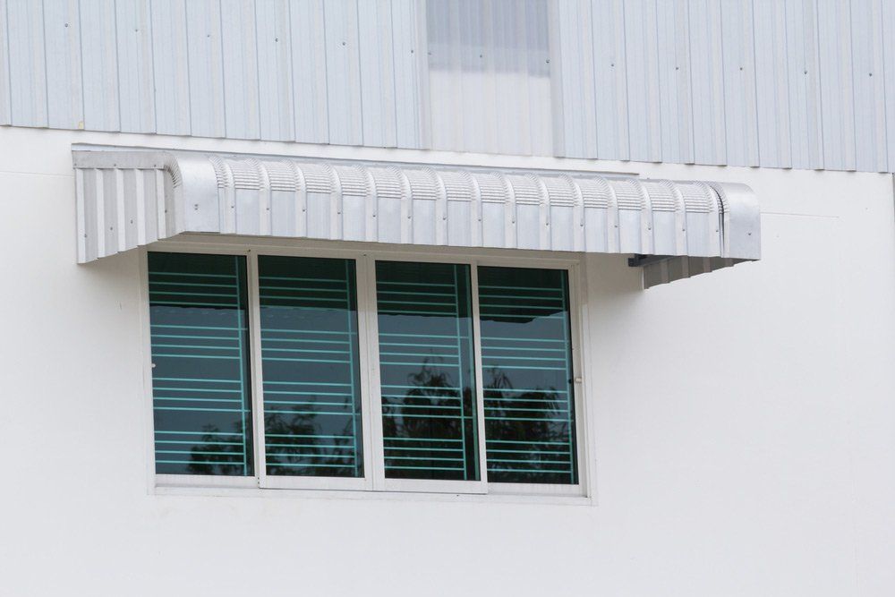 A Window On The Side Of A Building With A Canopy Over It — Summerland Screens & Awnings In Ballina, NSW