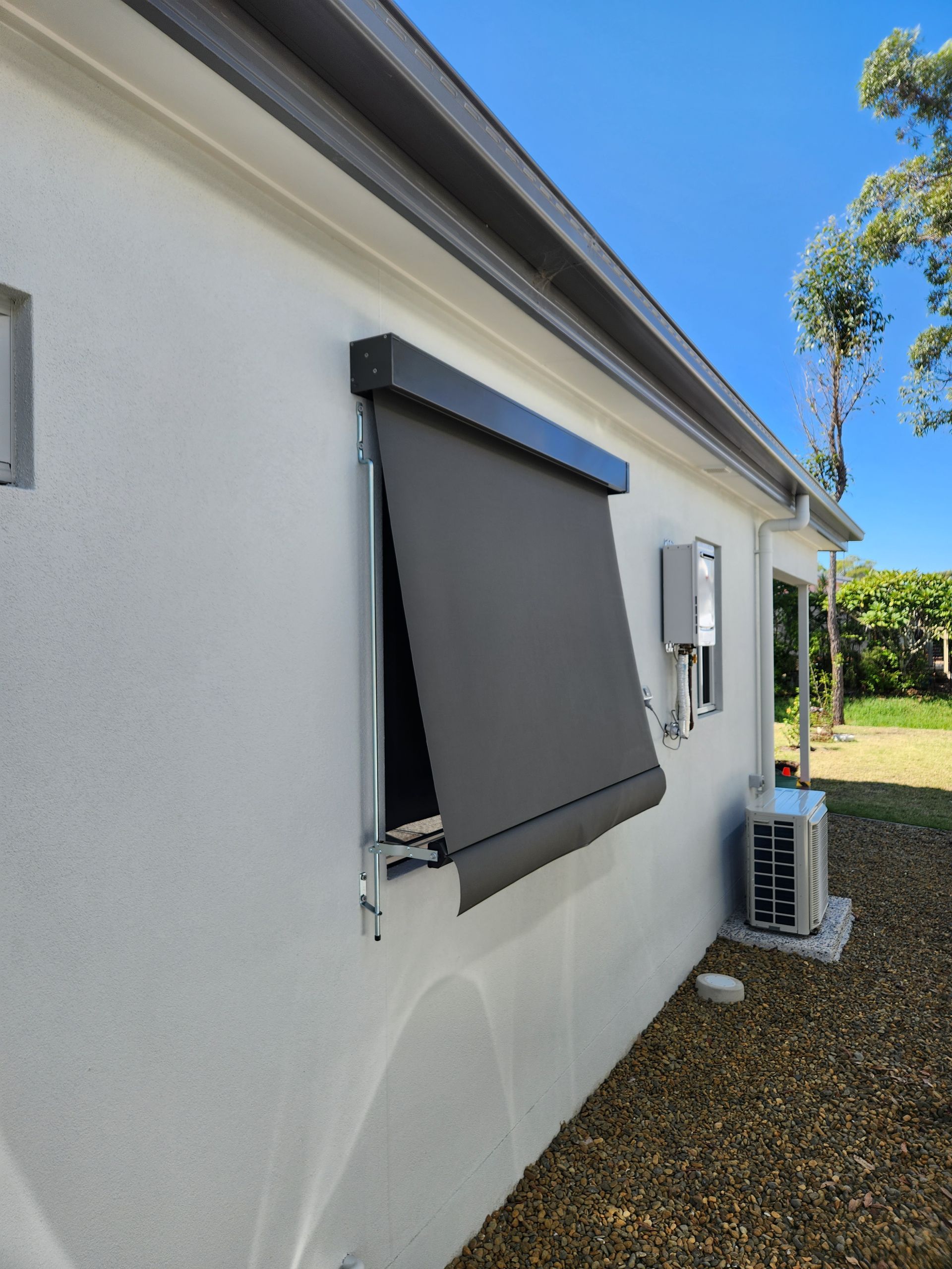 Automatic awning on the side of a  house— Summerland Screens & Awnings In Ballina, NSW