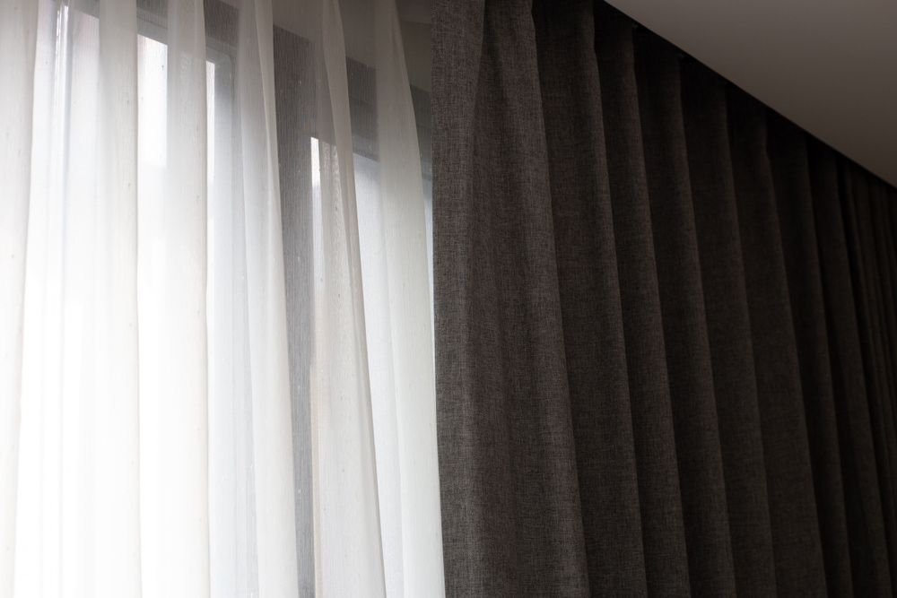 A Close Up Of A Window With Black Curtains And White Curtains — Summerland Screens & Awnings In Alstonville, NSW