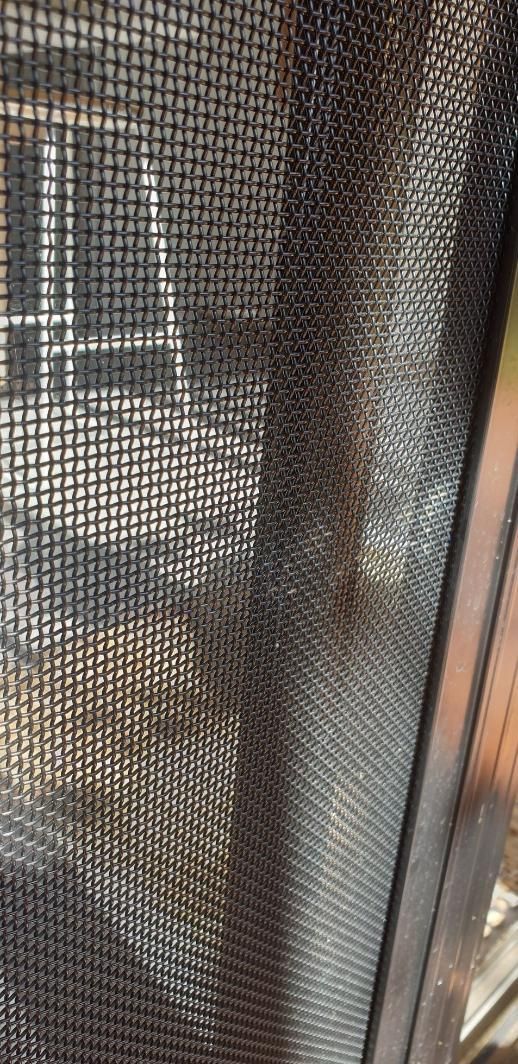 A Close Up Of A Screen Door With A Cat Behind It — Summerland Screens & Awnings In Ballina, NSW