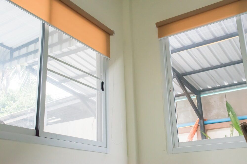 A Couple Of Windows With Blinds On Them In A Room — Summerland Screens & Awnings In Evans Head, NSW