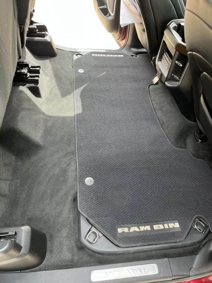 A black, textured floor mat labeled