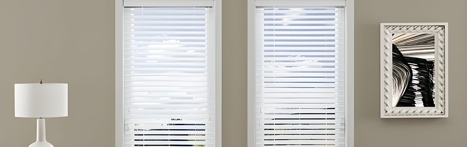 A room with a couch and a window with blinds on it.